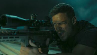 Zachary Beck holding a gun in Reacher Season 3.