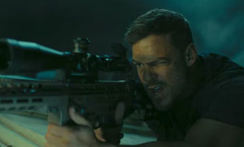 Zachary Beck holding a gun in Reacher Season 3.