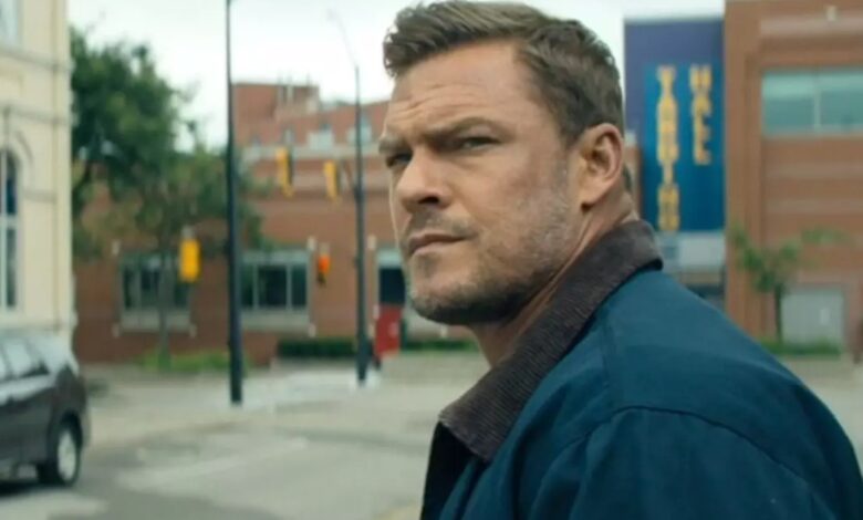 Zachary Beck holding a gun in Reacher Season 3.