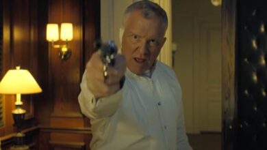 Quinn in front of a case of guns in Reacher Season 3.
