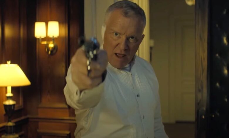 Quinn in front of a case of guns in Reacher Season 3.