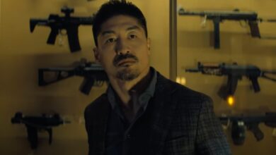 Zachary Beck holding a gun in Reacher Season 3.