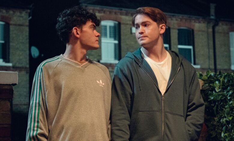 Nick and Charlie walk down the street in Heartstopper